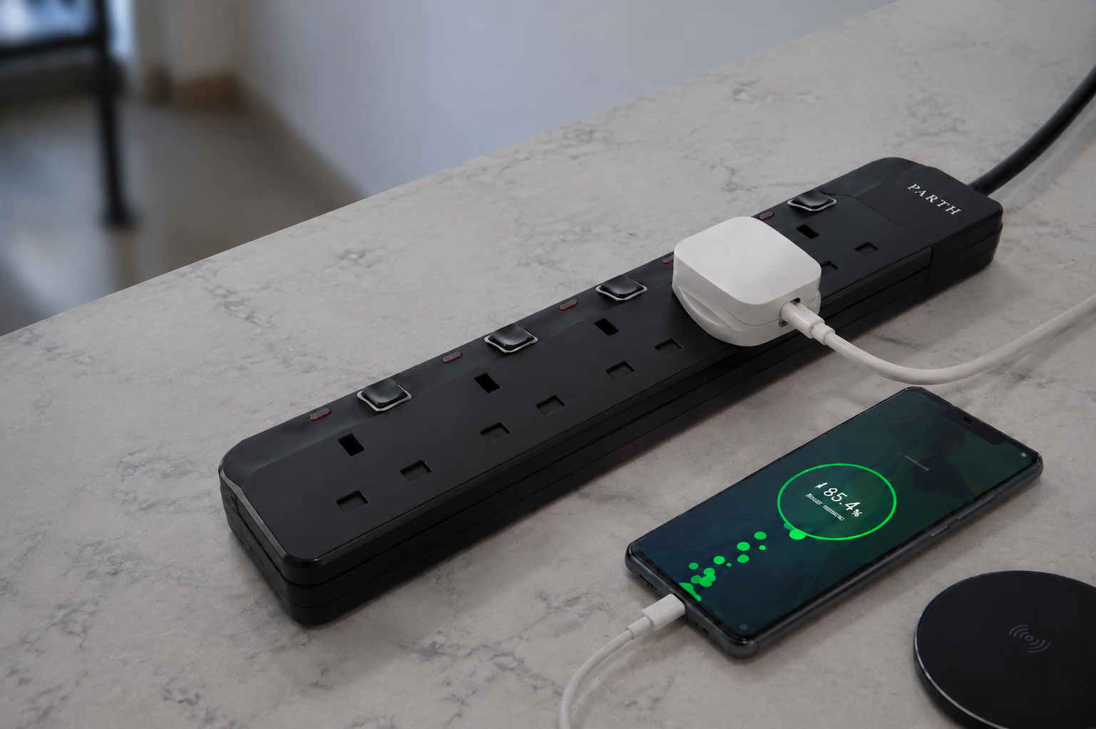 PARTH 3025 black 5-outlet extension lead powering a phone on a desk